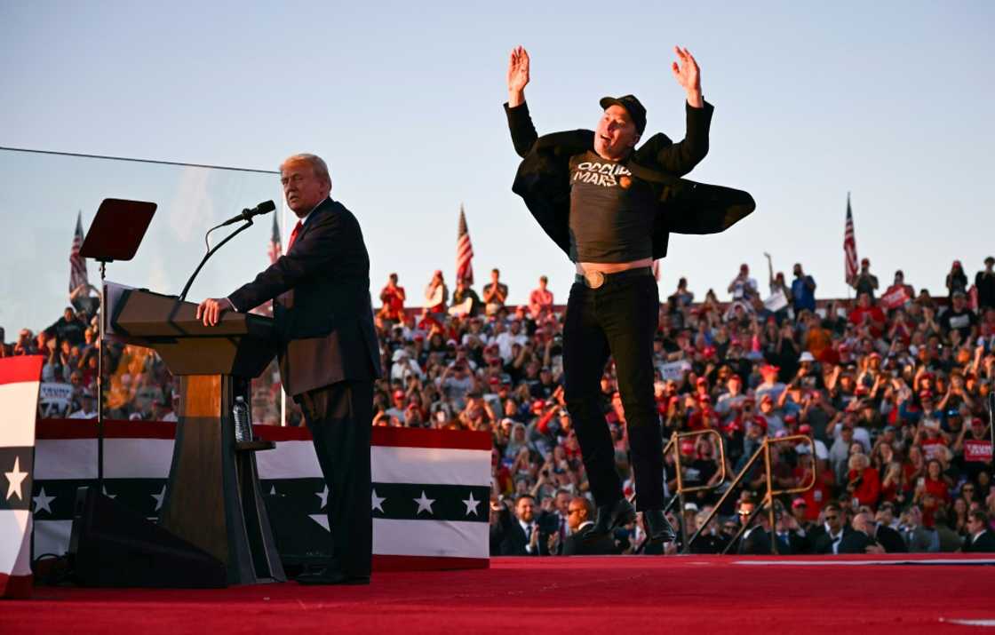 Elon Musk (R), shown joining Donald Trump on stage at a rally in Pennsylvania in October, is poised to have sweeping powers in the Republican's new administration