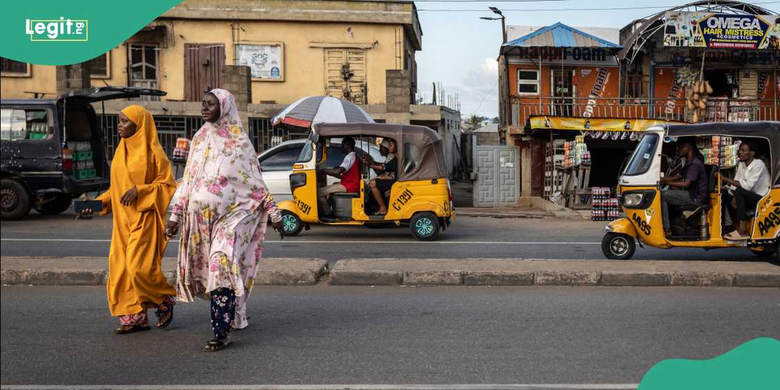 Nigerian road. Tricycle passing. Nigerian road. Tricycle passing.