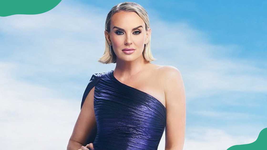 Whitney Rose in a shimmering navy against a bright sky backdrop. Whitney Rose in a shimmering navy against a bright sky backdrop.