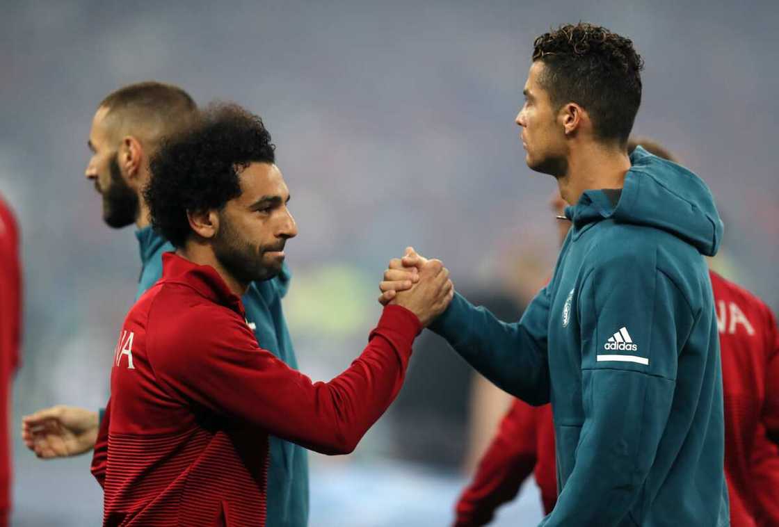 Mohamed Salah of Liverpool and Cristiano Ronaldo in action Mohamed Salah of Liverpool and Cristiano Ronaldo in action