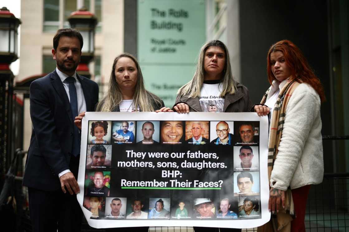 A banner outside the High Court in London showing victims of the mine disaster