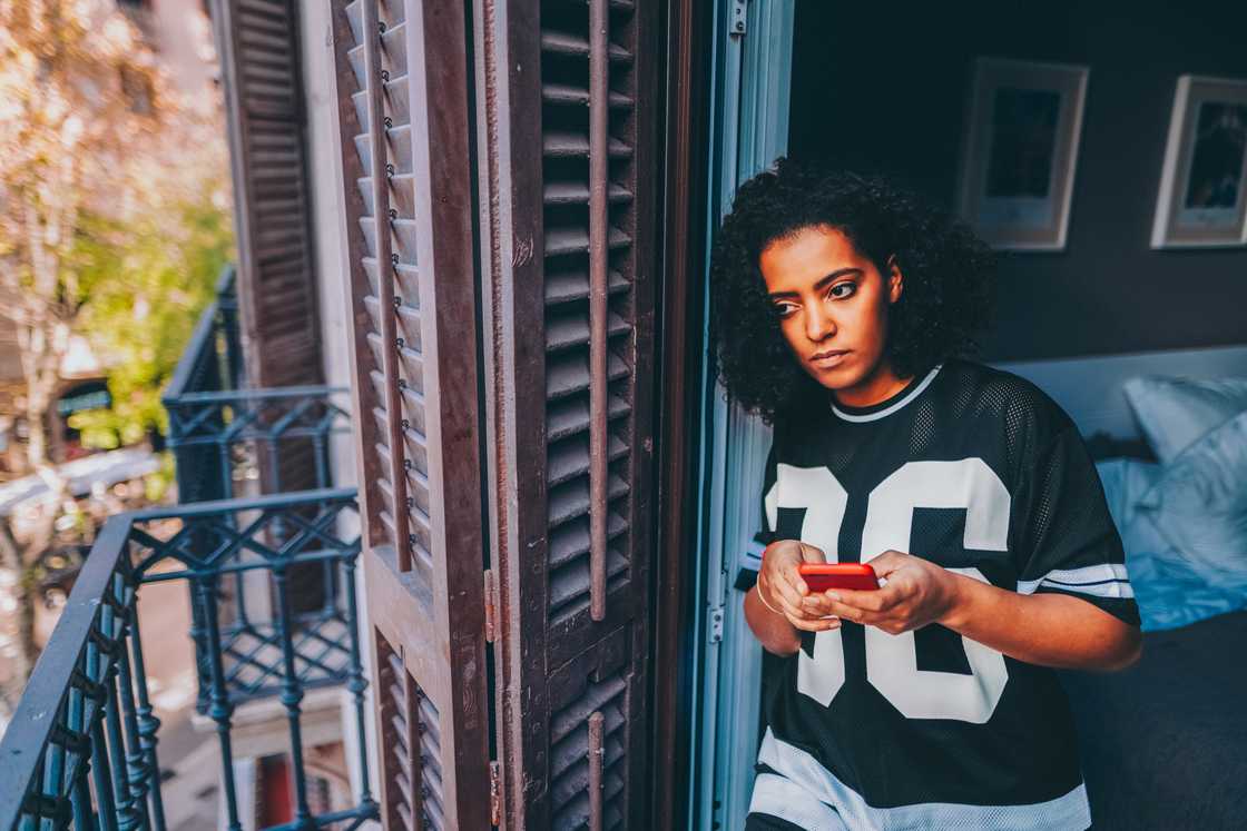 A lady taking a call from the balcony A lady taking a call from the balcony