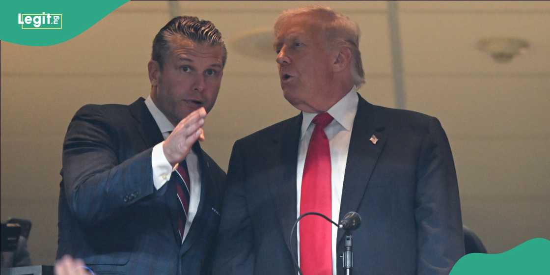 Secretary of War Pete Hegseth (L) speaks with U.S. President Donald Trump.