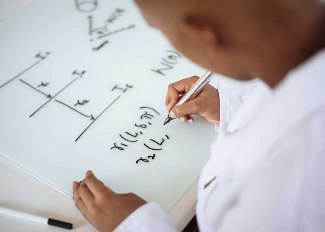 A student deriving a math formula A student deriving a math formula