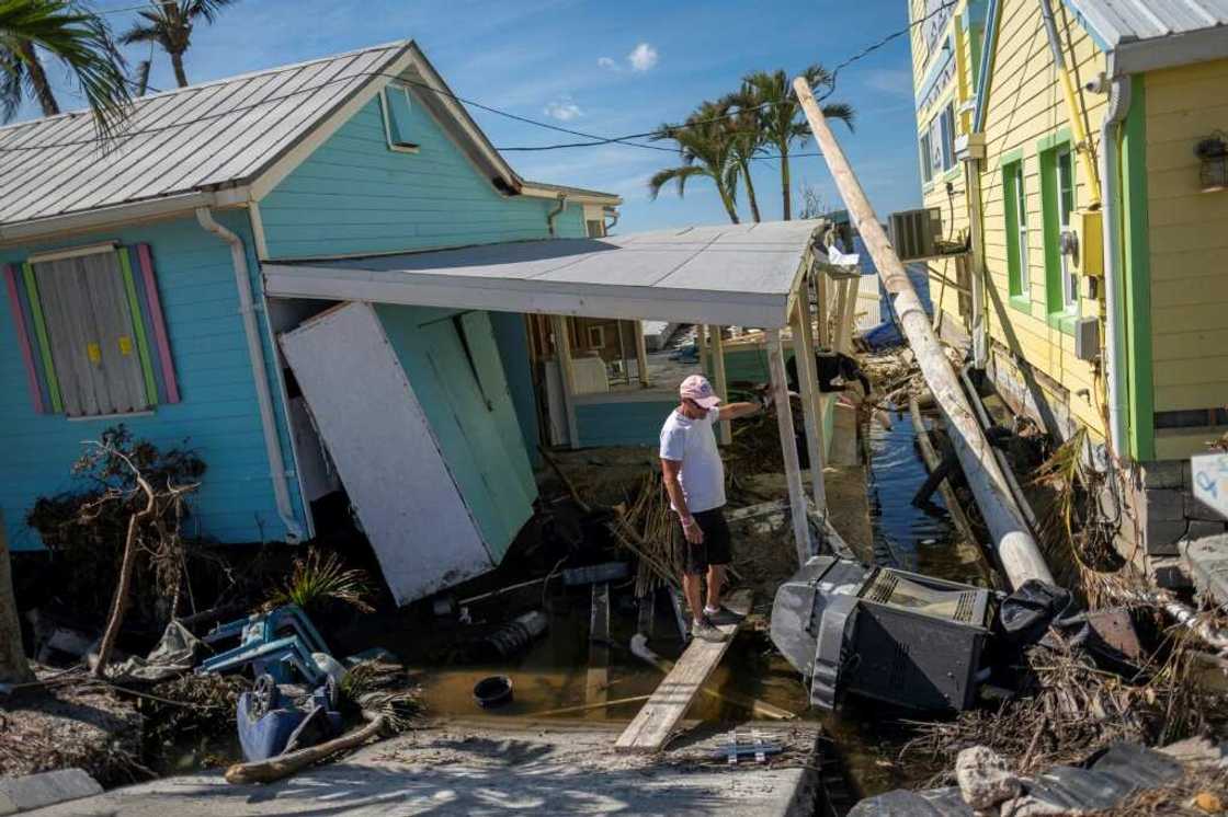 A man stands in front of his destroyed house in the aftermath of Hurricane Ian in Matlacha, Florida A man stands in front of his destroyed house in the aftermath of Hurricane Ian in Matlacha, Florida