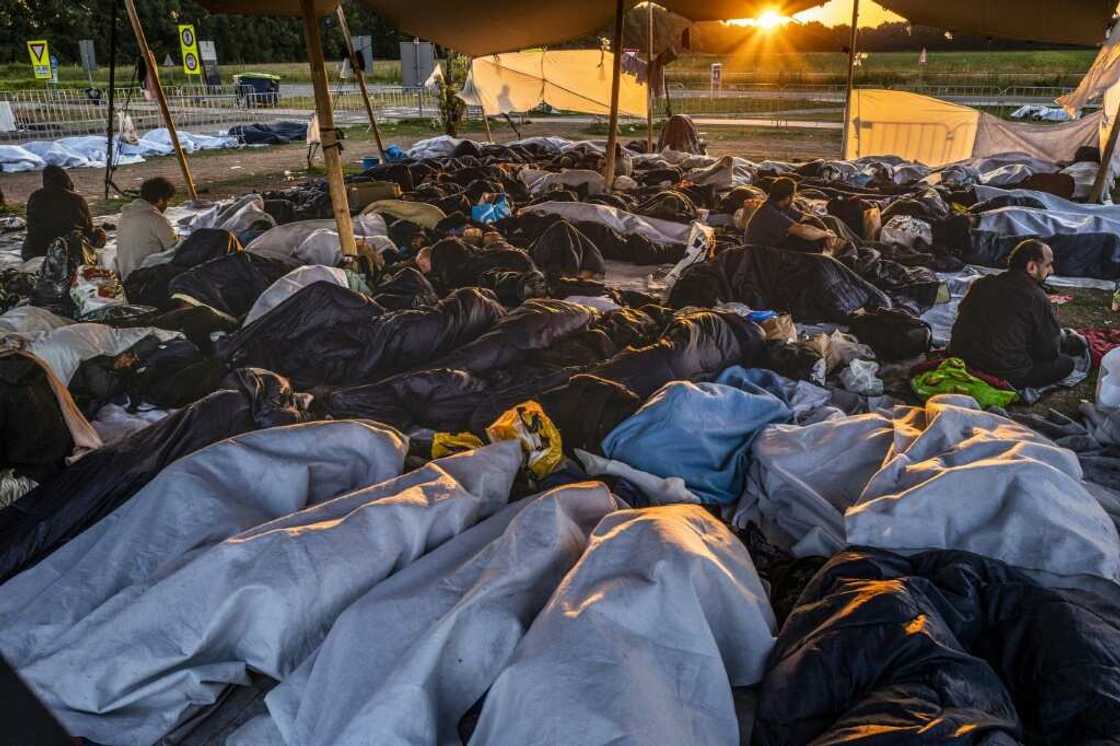 Hundreds of asylum seekers have been sleeping in front of the gates of the refugee centre Hundreds of asylum seekers have been sleeping in front of the gates of the refugee centre
