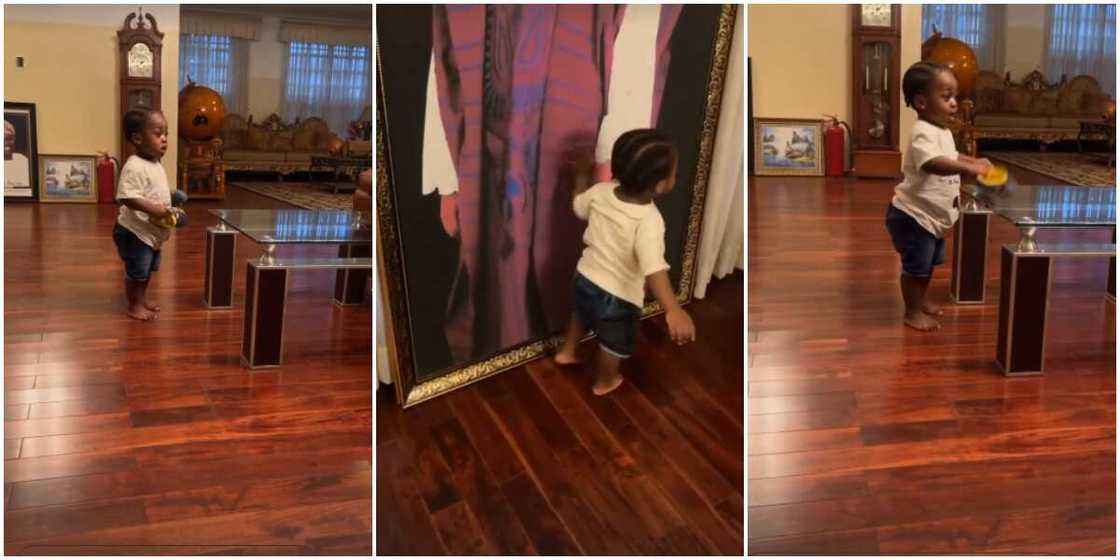 Heir apparent: Davido proudly shows off Ifeanyi as he plays and admires photos in his grandfather's house Heir apparent: Davido proudly shows off Ifeanyi as he plays and admires photos in his grandfather's house