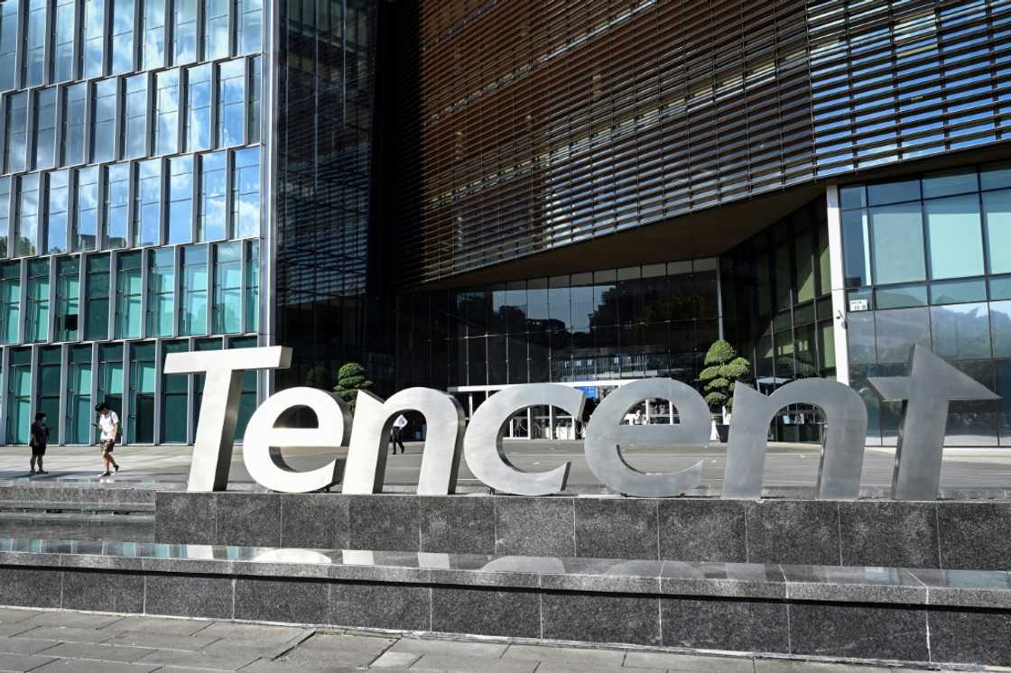 People walking past the Tencent headquarters in Shenzhen in China's southern Guangdong province People walking past the Tencent headquarters in Shenzhen in China's southern Guangdong province