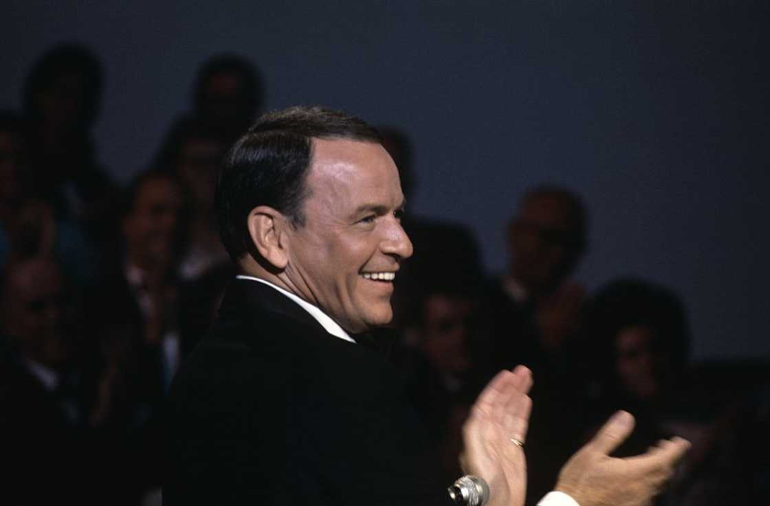 Singer and histrion  Frank Sinatra clapping hands during a performance