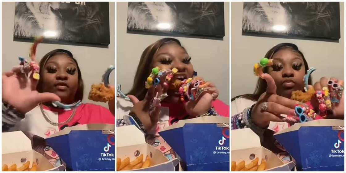 Lady eating chicken with long nails. Lady eating chicken with long nails.