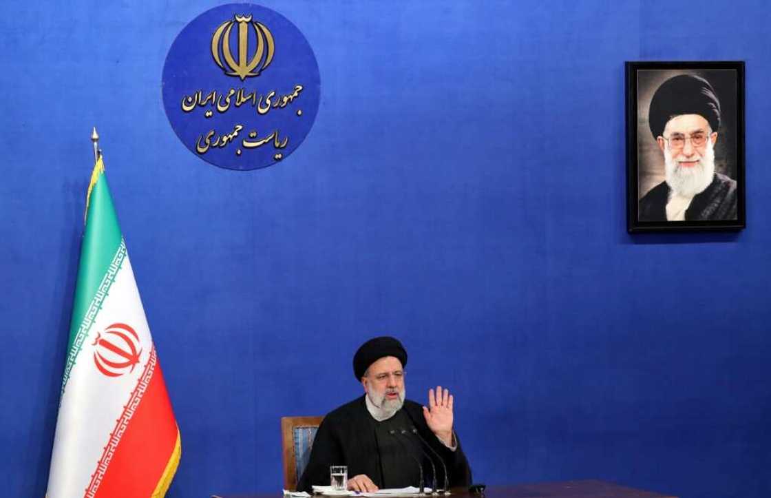 Iranian President Ebrahim Raisi sits near a portrait of Iran's Supreme Leader Ayatollah Ali Khamenei as he speaks during a press conference in Tehran on August 29, 2022 Iranian President Ebrahim Raisi sits near a portrait of Iran's Supreme Leader Ayatollah Ali Khamenei as he speaks during a press conference in Tehran on August 29, 2022