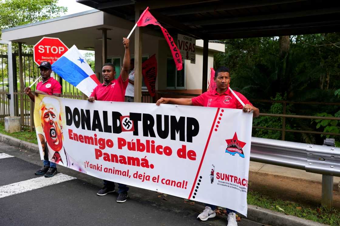 Demonstrators hold a banner that reads 'Donald Trump, public enemy of Panama,' during a protest outside the US embassy on December 24, 2024