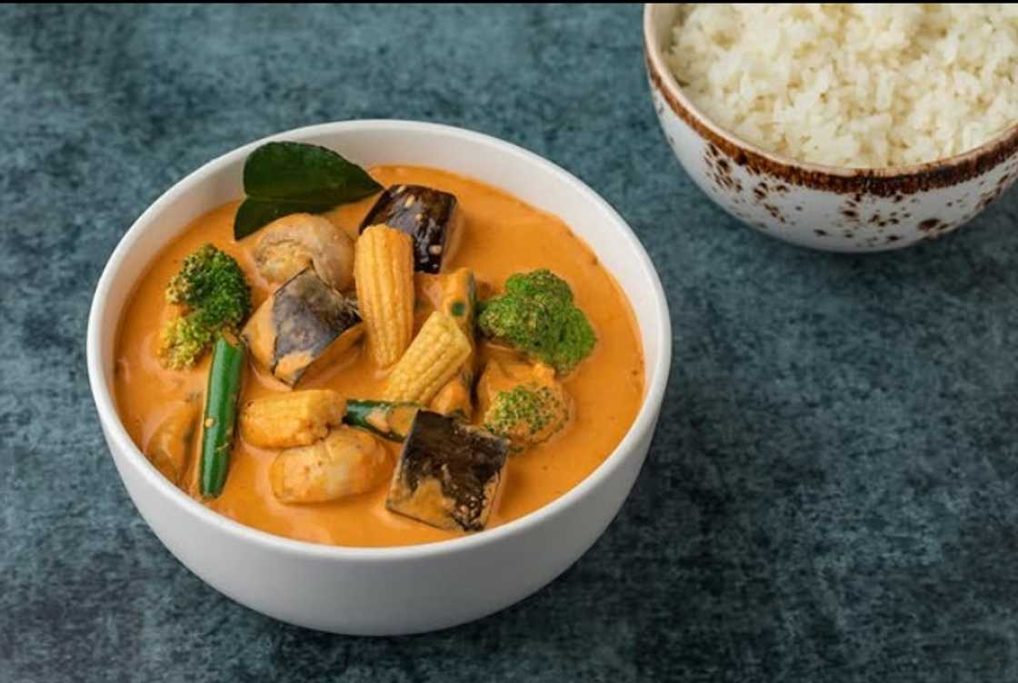 A bowl of Panang curry with rice on the side A bowl of Panang curry with rice on the side