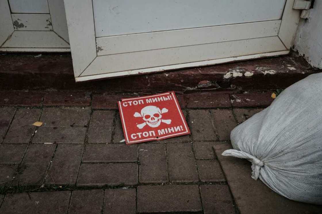 A mine sign outside the destroyed railway building at Kozacha Lopan, a retaken town in the eastern Ukrainian border region of Kharkiv A mine sign outside the destroyed railway building at Kozacha Lopan, a retaken town in the eastern Ukrainian border region of Kharkiv