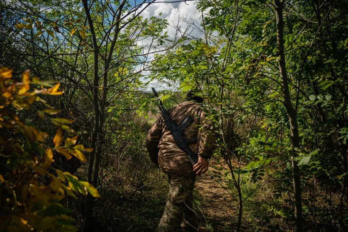A Ukrainian soldier patrols at a position along the front line in the Mykolaiv region A Ukrainian soldier patrols at a position along the front line in the Mykolaiv region