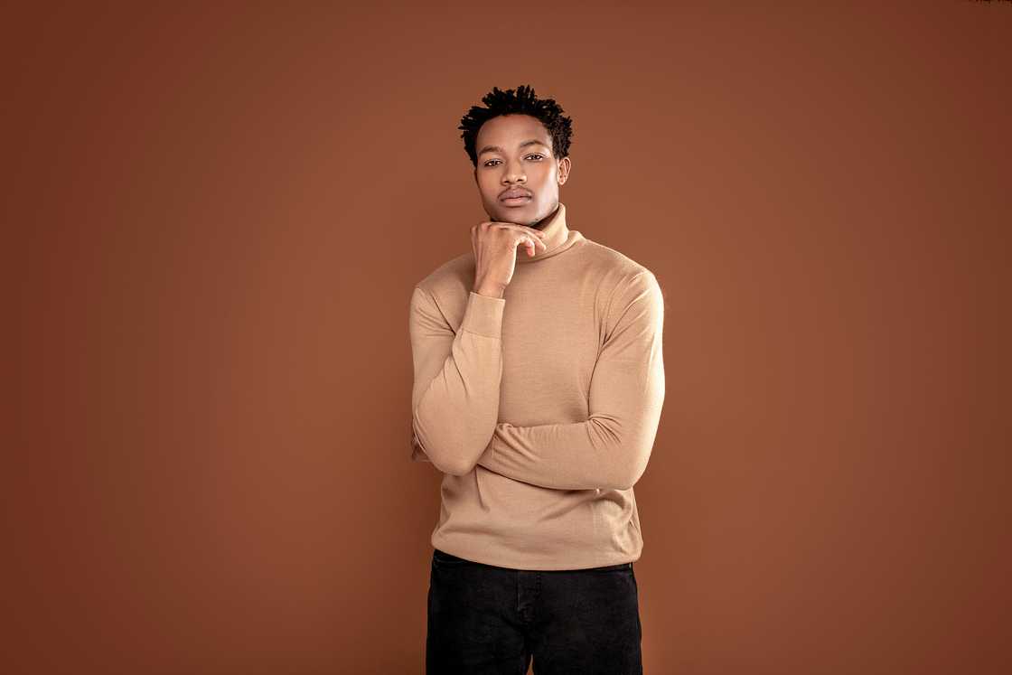 A young man wearing a brown turtlenecks.