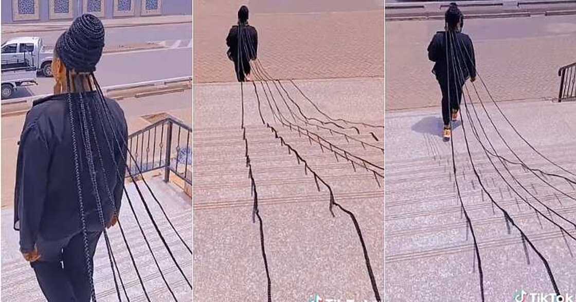 Lady sweeps floor with long braids, extremely long