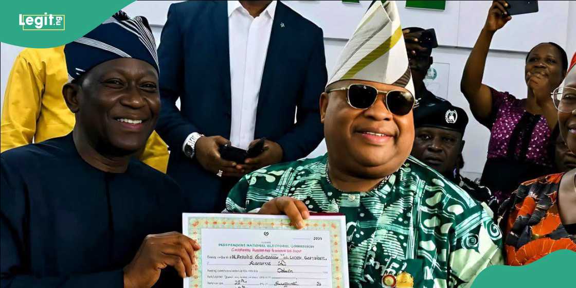 INEC Resident Electoral Commissioner Kunle Ajani presents Adeleke with his Certificate of Return.