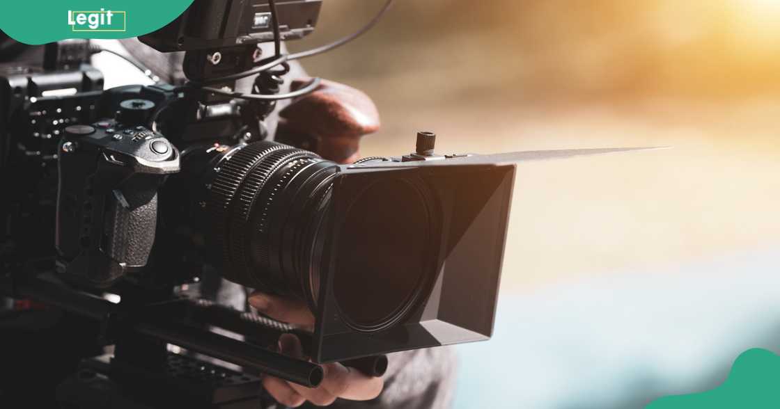 A filmmaker uses a cinema camera to shoot film footage. A filmmaker uses a cinema camera to shoot film footage.