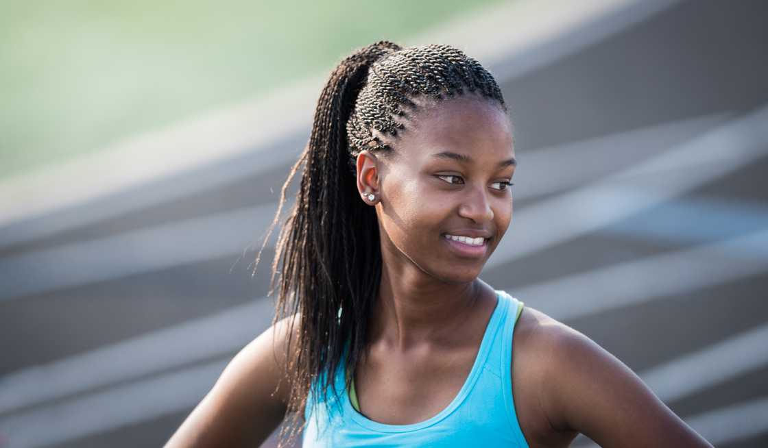 A teen athlete smiling after winning a race
