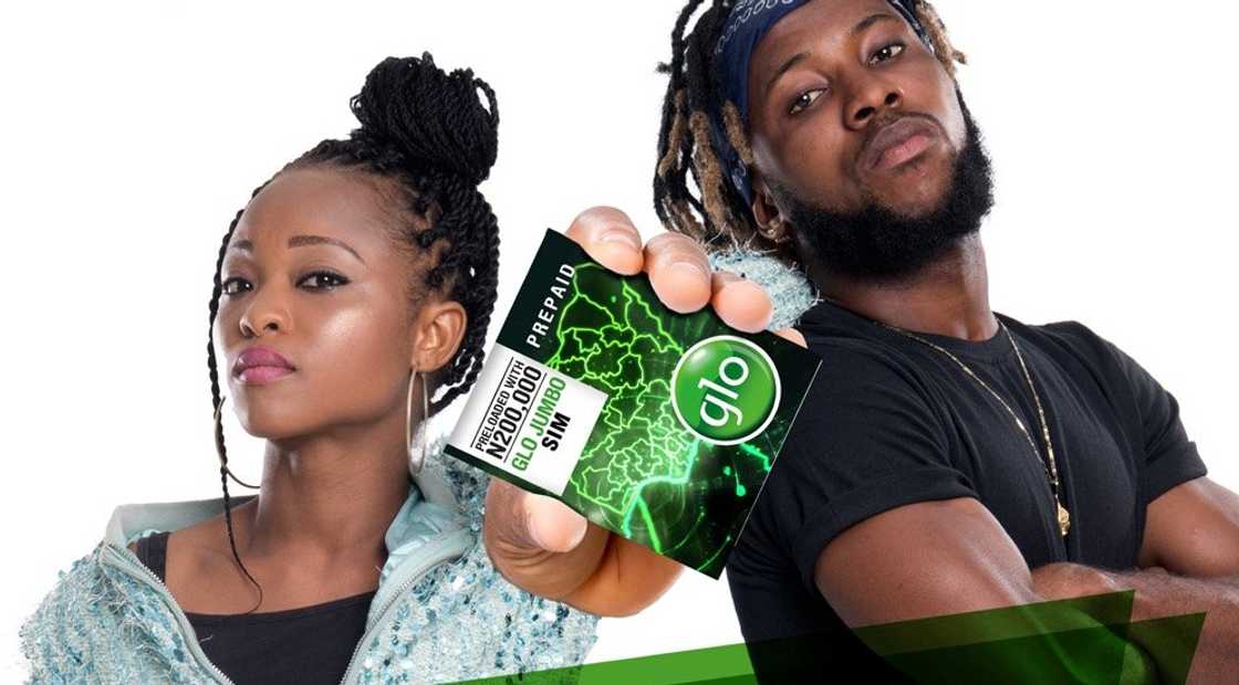 Two young people hold a Glo Mega SIM card Two young people hold a Glo Mega SIM card
