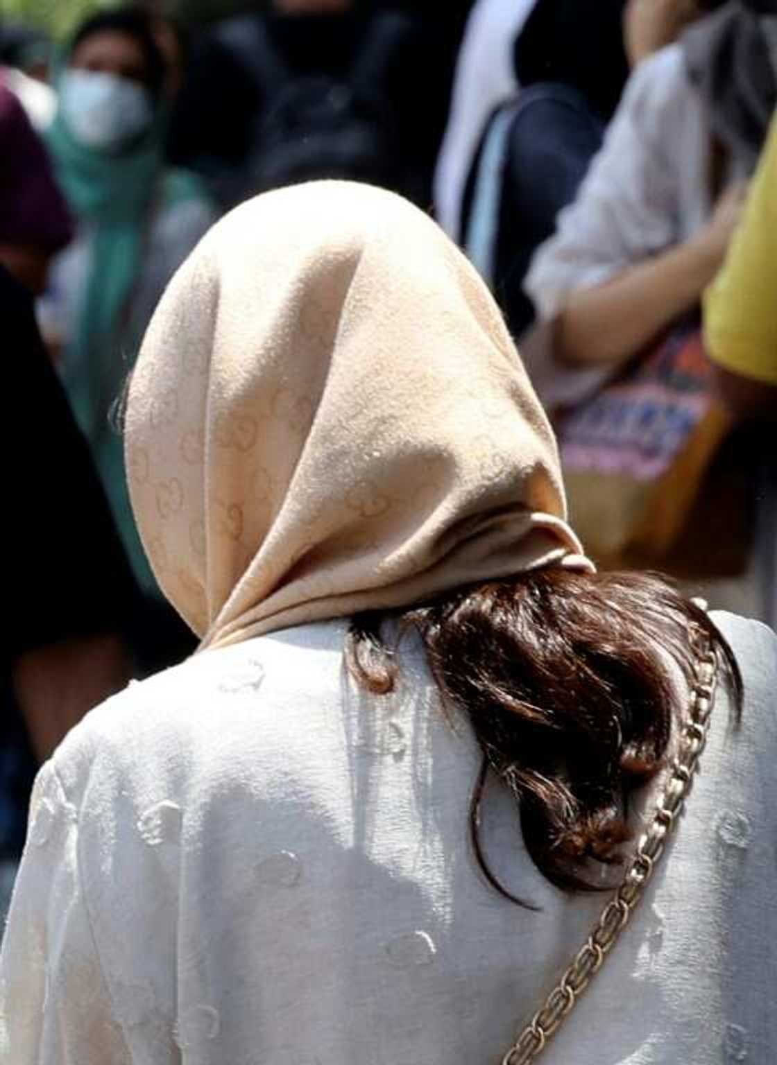 A woman wearing a headscarf crosses a street in Tehran -- especially in Iran's major cities many have pushed the boundaries to reveal more hair A woman wearing a headscarf crosses a street in Tehran -- especially in Iran's major cities many have pushed the boundaries to reveal more hair