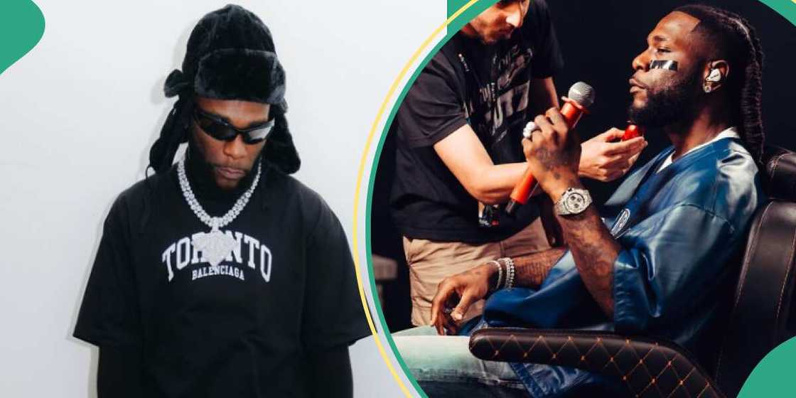 Burna Boy drags his backup singer in front of large crowd.