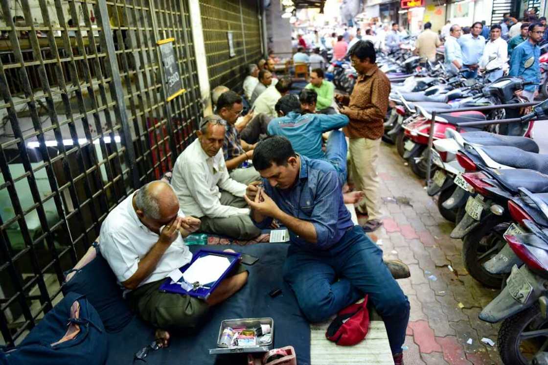 Diamond traders in the west Indian city of Surat, where 90 percent of the world's diamonds are cut and polished