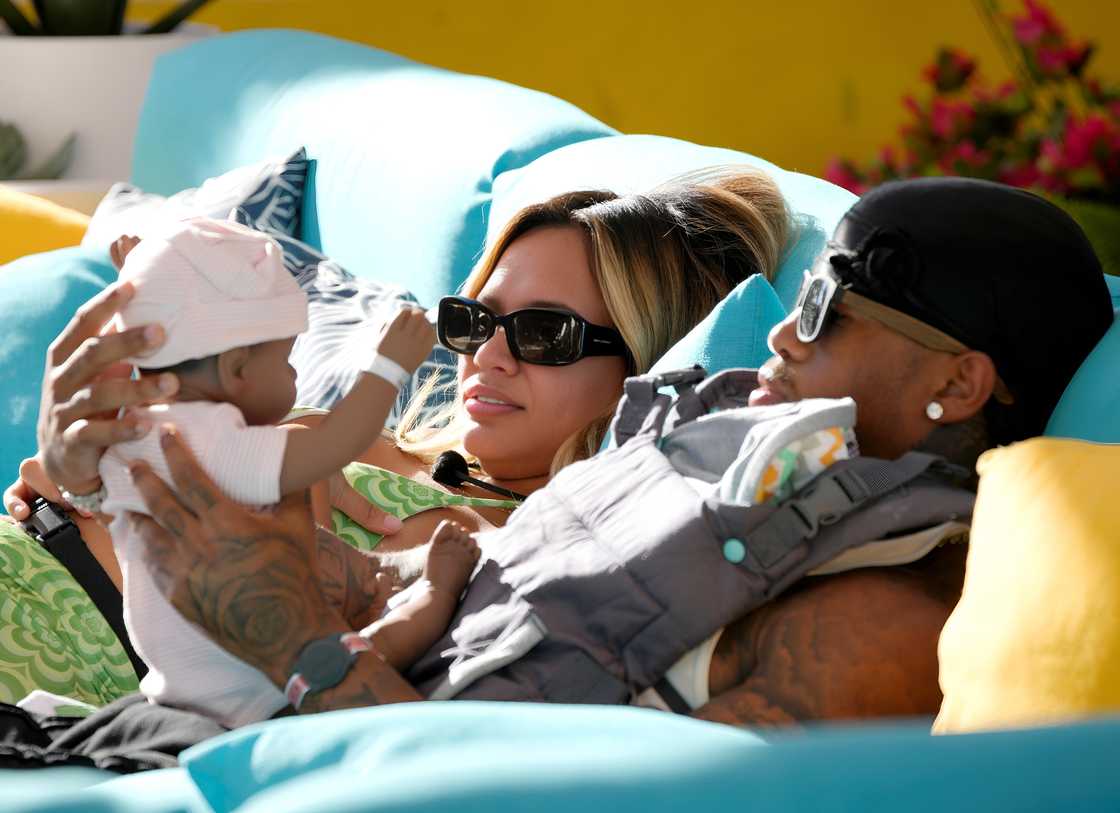 Nadjha Day and Jeff Christian Jr. take care of a realistic baby doll while filming