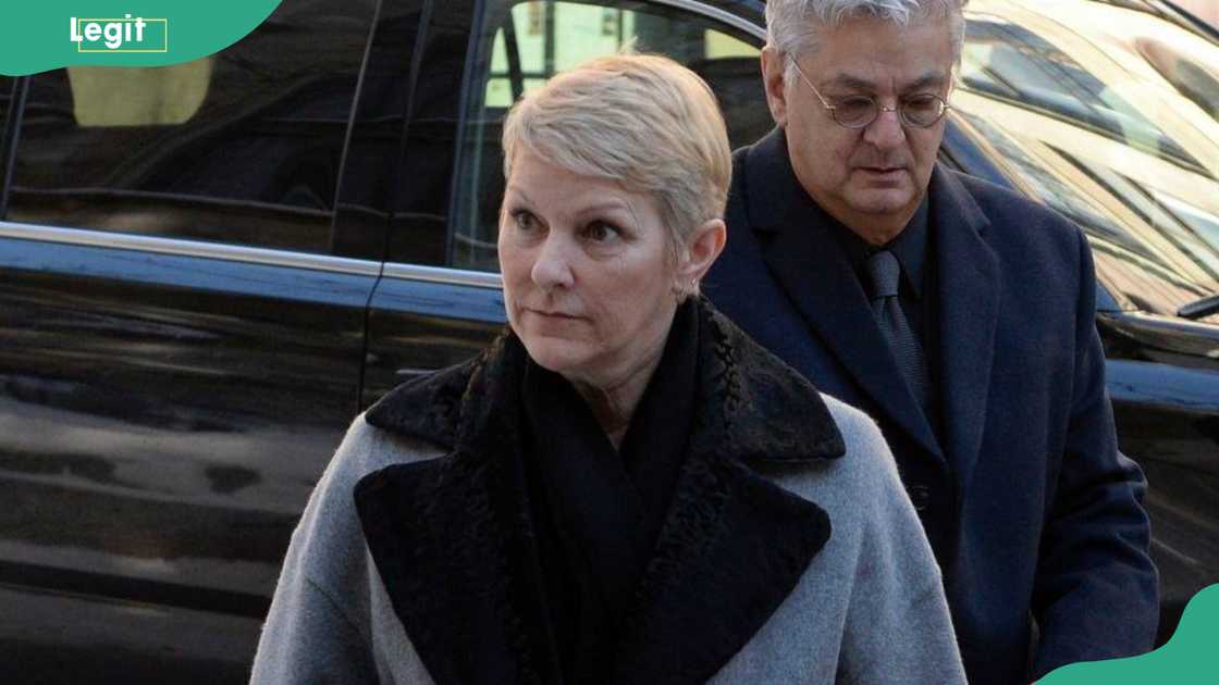 Linda Dion posing in front of a black car Linda Dion posing in front of a black car