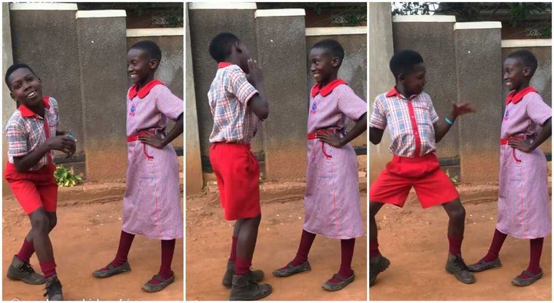 Black kid dancing in front of pretty black girl.