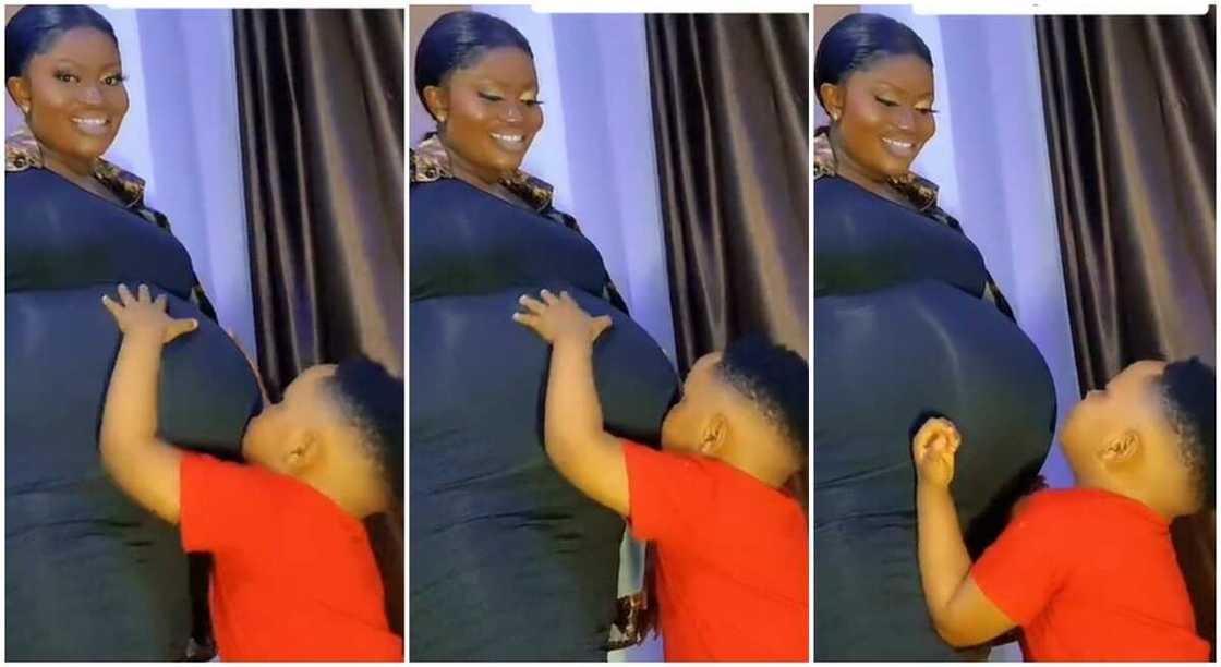 Photos of adorable black boy admiring his mum's cute baby bump. Photos of adorable black boy admiring his mum's cute baby bump.