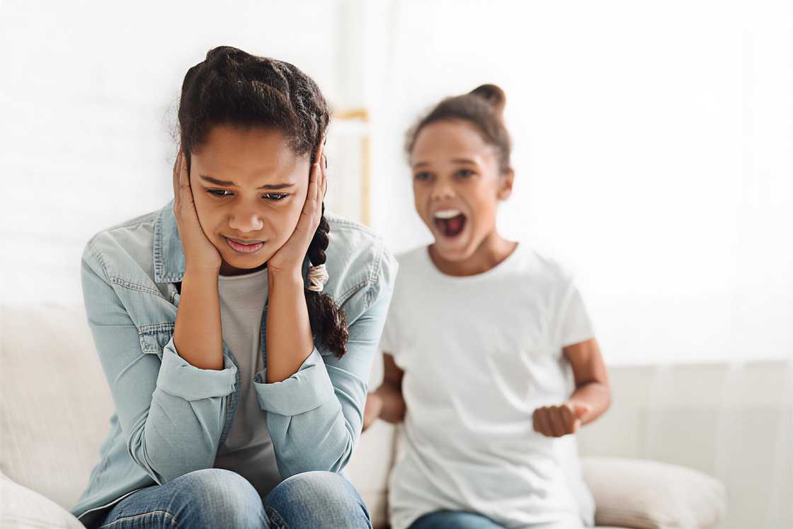 A hysterical black girl yelling at her older sister A hysterical black girl yelling at her older sister
