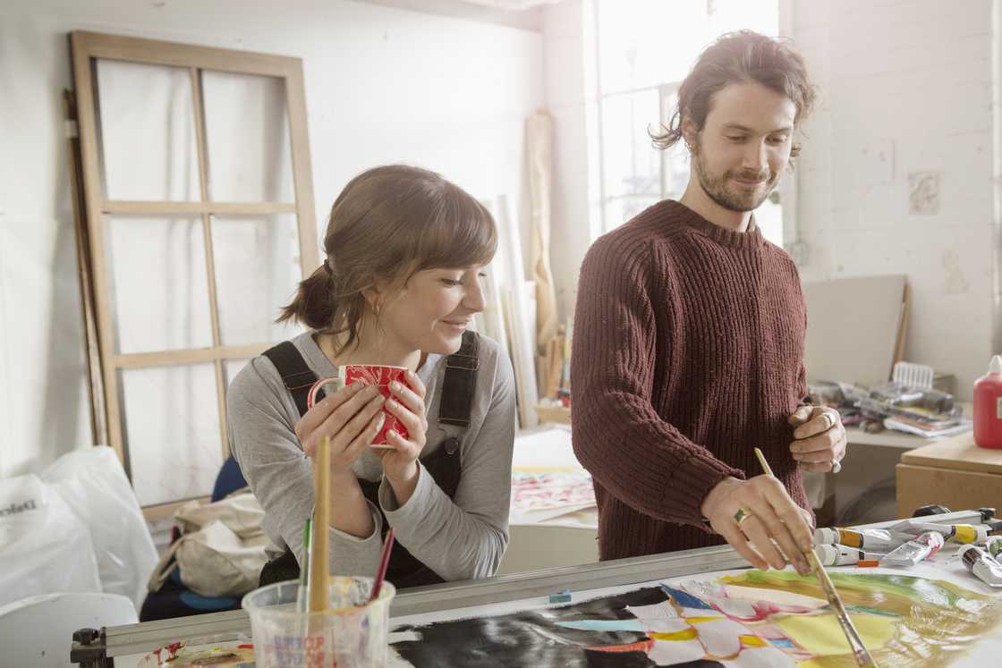 A young couple doing painting. A young couple doing painting.