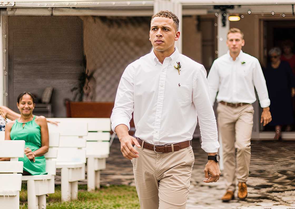 Meet Jake from The Ultimatum walking in beige trouser and white shirt