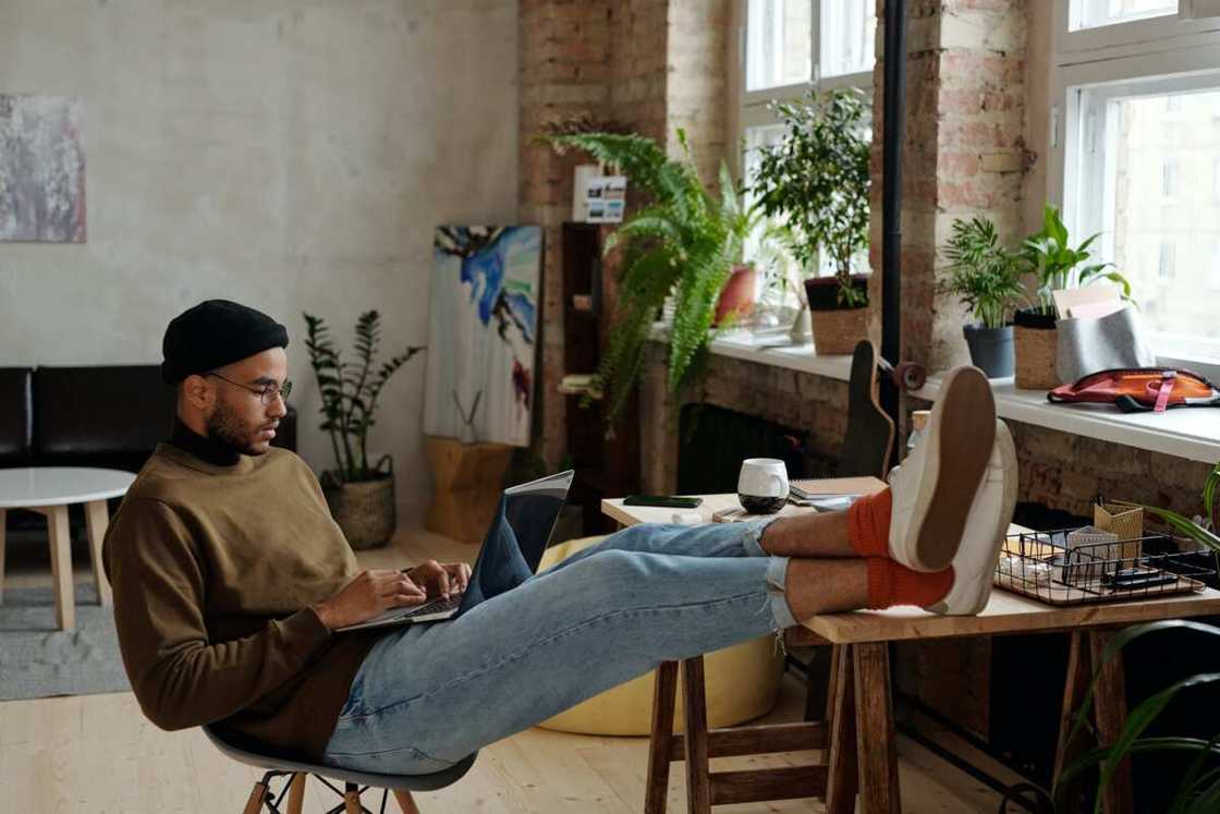 A person relaxing while using his computer