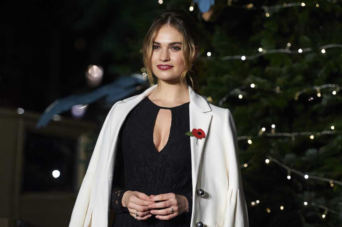 British actress Lily James poses for photographers during a Christmas photo call outside Harrods department store in London, England
