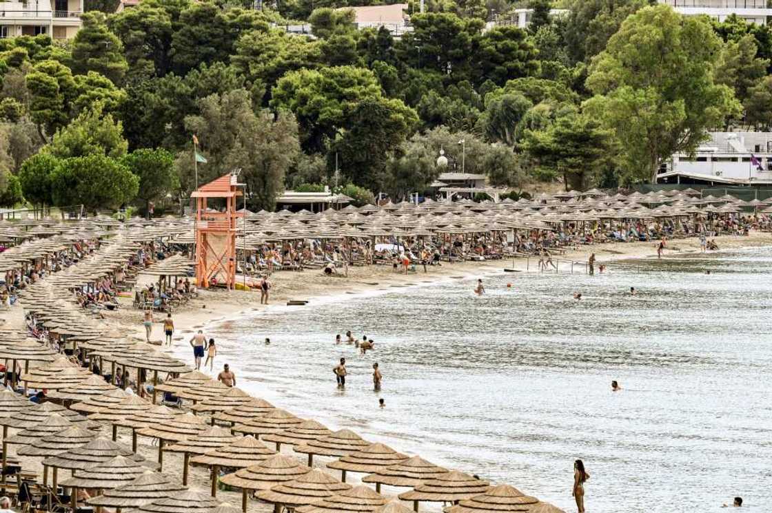 Oceanis beach, south of Athens, is packed with parasols and sun loungers Oceanis beach, south of Athens, is packed with parasols and sun loungers
