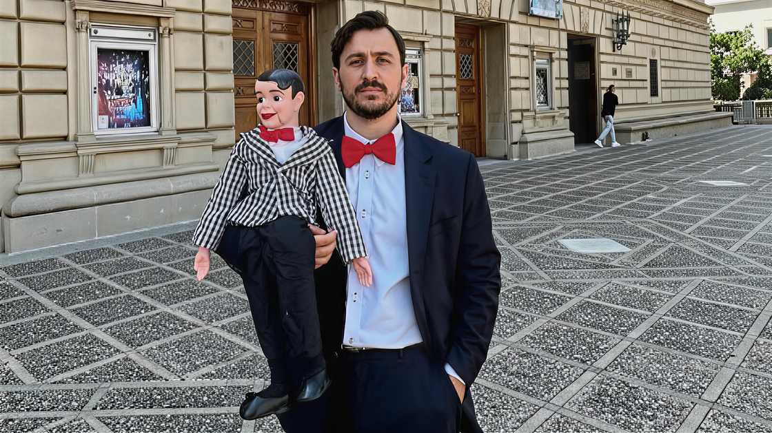 Jake Nordwind poses with a ventriloquist dummy