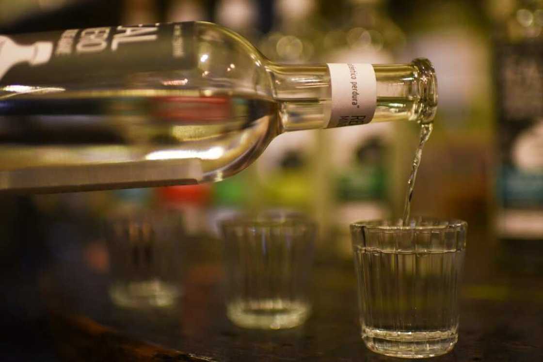 Mezcal is traditionally sipped neat, accompanied by slices of orange and salt mixed with dried chiles and ground agave worms, but it can also increasingly be found on cocktail menus Mezcal is traditionally sipped neat, accompanied by slices of orange and salt mixed with dried chiles and ground agave worms, but it can also increasingly be found on cocktail menus