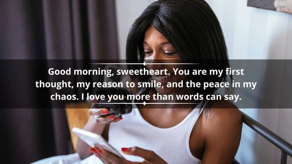 A pistillate is drinking java and utilizing a mobile telephone successful bed A pistillate is drinking java and utilizing a mobile telephone successful bed