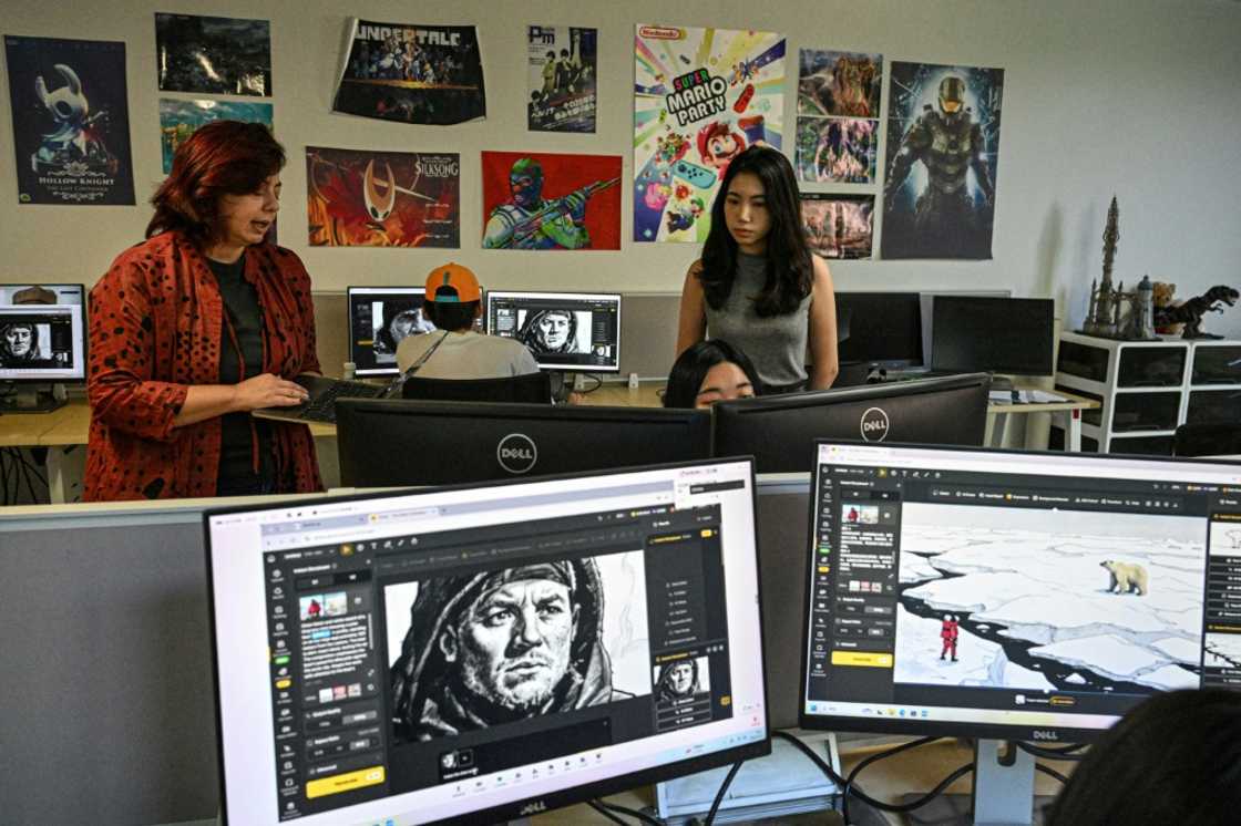 Odet Abadia (L) teaching students to use Dzine, an AI image editing platform, at an AI filmmaking course at the Shanghai Vancouver Film School