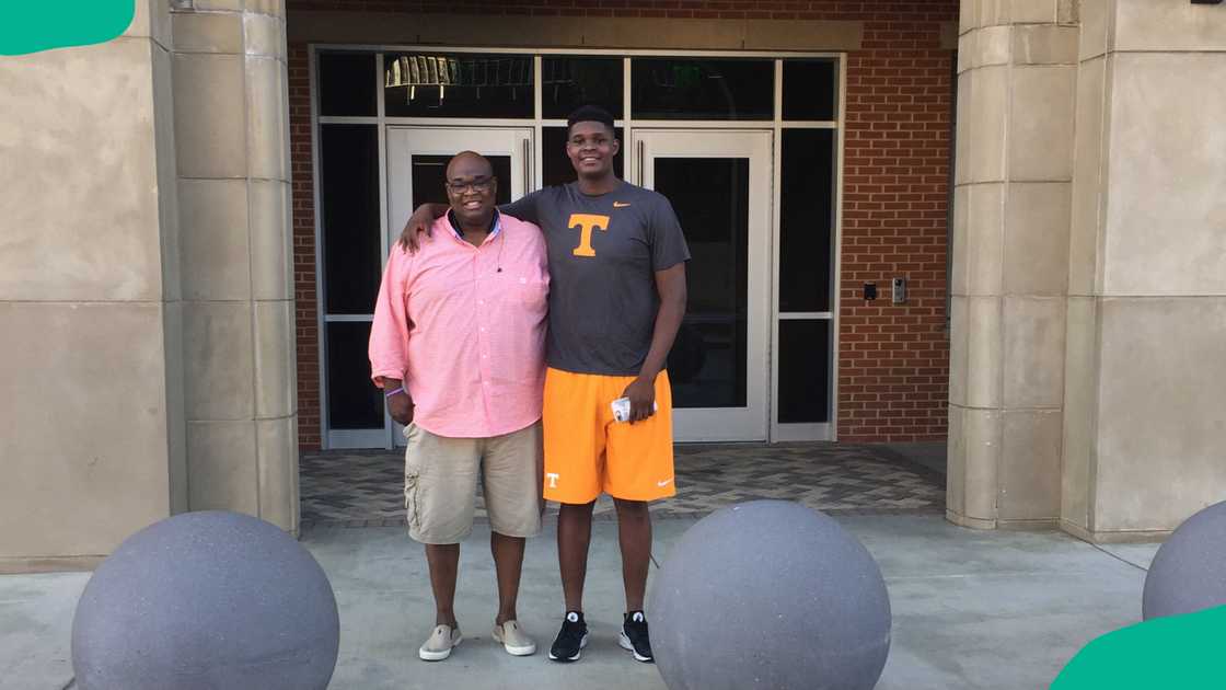 Dwight Sr. posing outdoors with his son, DJ Burns