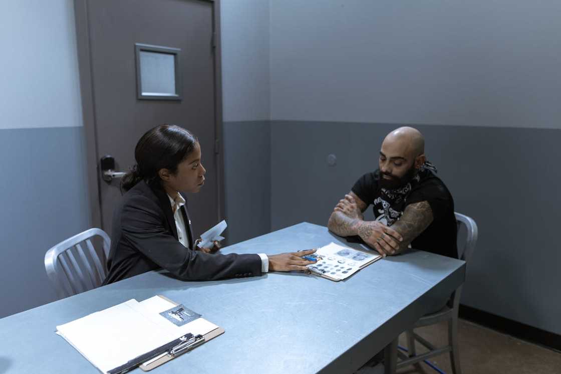 Investigators question a man at the police station. Investigators question a man at the police station.