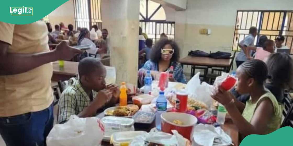 Children eating with their aunt Children eating with their aunt