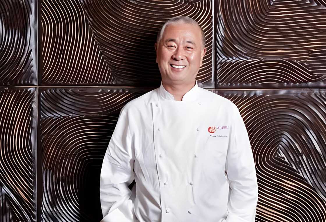 Nobu Matsuhisa poses against a wooden wall. Nobu Matsuhisa poses against a wooden wall.