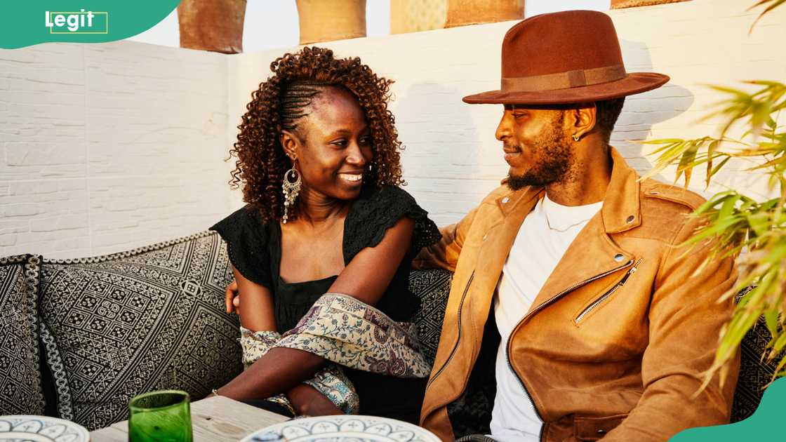 Smiling couple dining at rooftop restaurant Smiling couple dining at rooftop restaurant