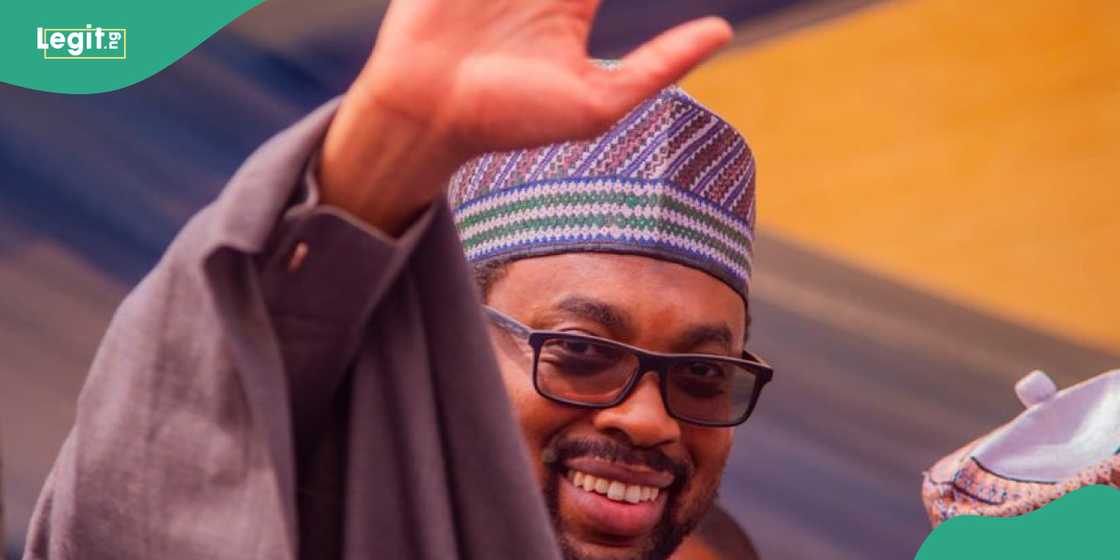 Ganduje's son waves at cheering crowd. Ganduje's son waves at cheering crowd.