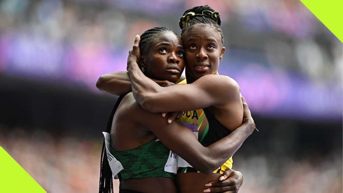 Tobi Amusan embraces Jamaica's Danielle Williams after 100m hurdles heat.