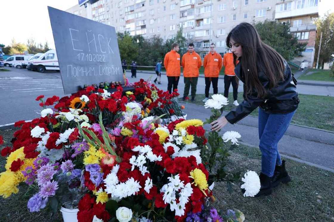 People lay flowers at a makeshift memorial for those killed after a Sukhoi Su-34 military jet crashed in the courtyard of a residential area in the town of Yeysk in southwestern Russia People lay flowers at a makeshift memorial for those killed after a Sukhoi Su-34 military jet crashed in the courtyard of a residential area in the town of Yeysk in southwestern Russia
